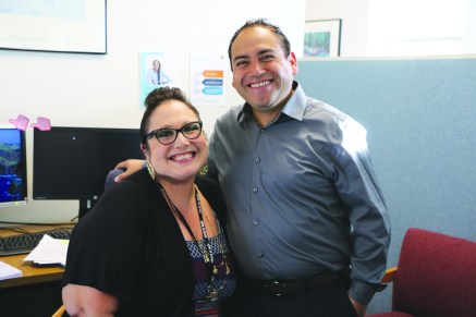 Carlos Ramos, pyschosocial rehabilitation specialist, and Christine Poff, client services technician, pause for a photo before starting their work day in Family and Community Services. See page 3 to read about a day in the life of Carlos.