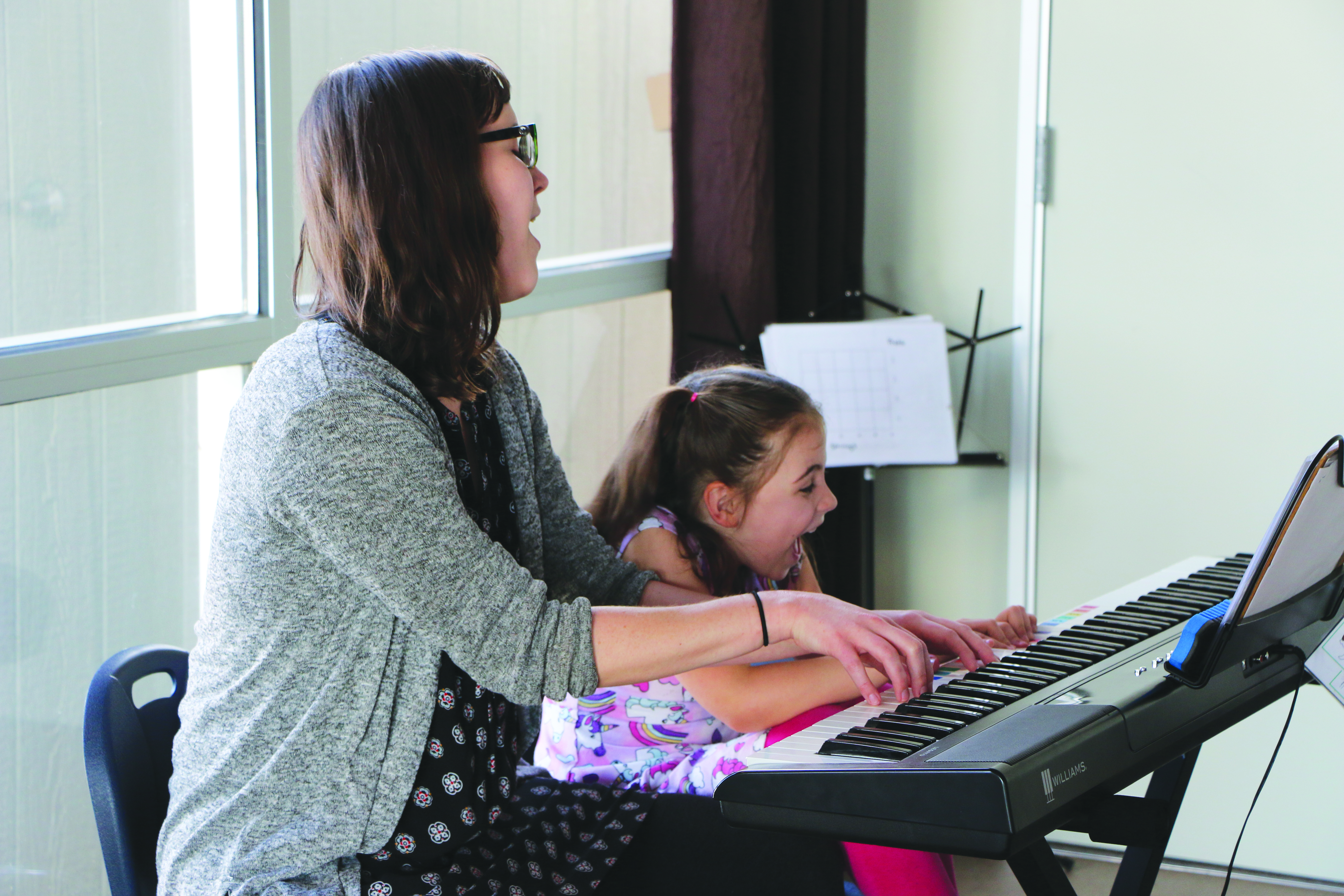 Kate Schnieder, board-certified music therapist at The Lotus Tree Sensory Integration Center in Boise, guides her piano duet with Client N as they work up to the grand finale of their piano duet.